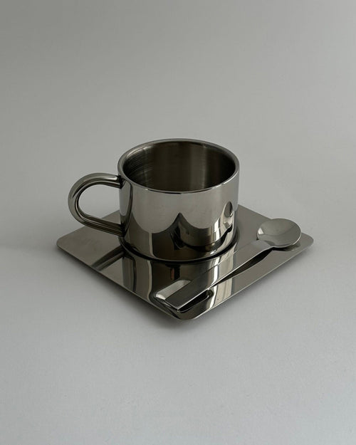 'HEDONISM' stainless steel cup with saucer